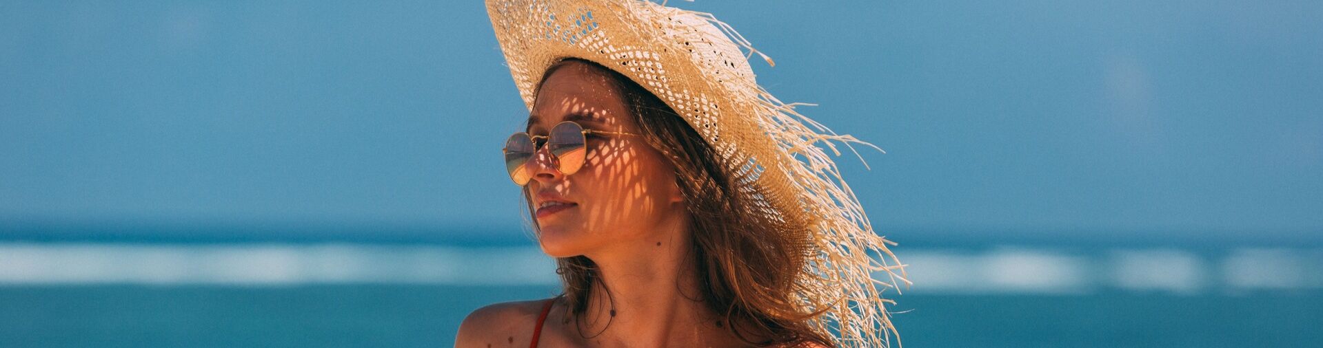 tanned woman sitting on the beach
