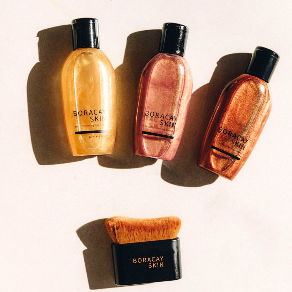 Boracay Skin All That Shimmers Bundle shown together in natural light with Bronze, Gold and Rose Gold body oils and kabuki brush