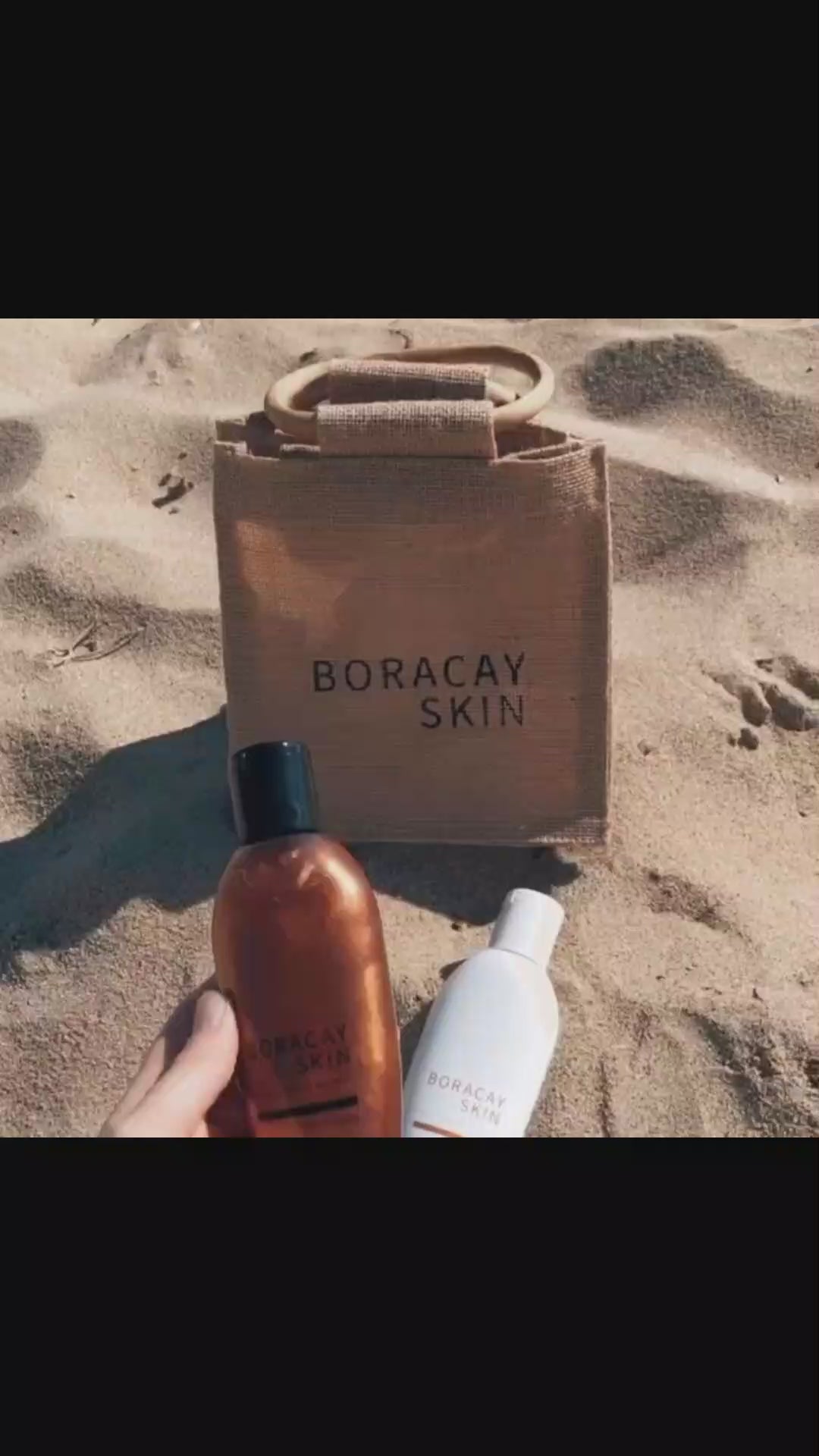 Video showing Boracay Skin jute bag on the sand at the beach with body oil products resting against the jute bag